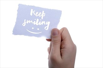 Keep smiling text on paper on a white background,