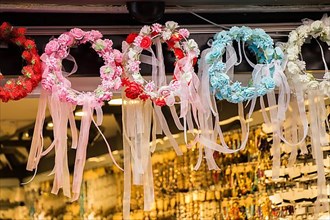 Colorful crowns for sale made of fake flowers,
