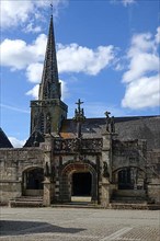 Enclosed parish Enclos paroissial Eglise Saint-Salomon de La Martyre with Gothic Flamboyant-style triumphal arch, Finistere department
