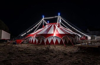 Small red illuminated circus tent at night, Rutesheim