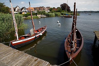 Wooden boats on the Schlei in front of the historic fishing village of Holm, Schleswig