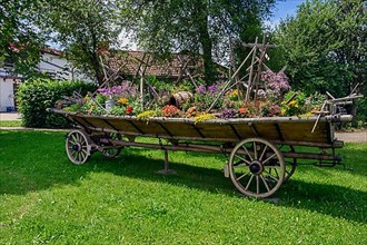 Old hay cart with floral decorations and hay candles, Buchenberg
