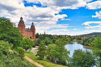 Beautiful view over German city Aschaffenburg with Main river, palace called Schloss Johannisburg and green park on sunny summer day