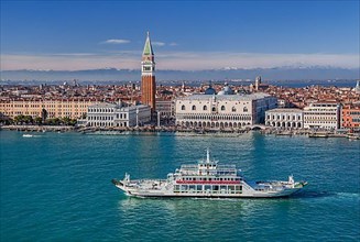 Car ferry in front of the waterfront on the lagoon with Piazzetta, Campanile and Doge's Palace in front of the Alpine chain
