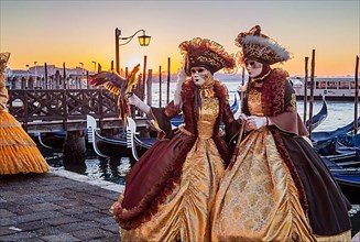 Carnival masks on the waterfront at sunrise, Venice