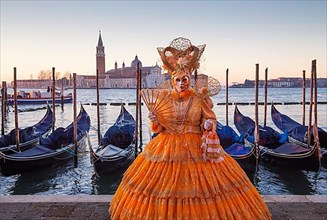 Carnival mask on the waterfront at sunrise, Venice