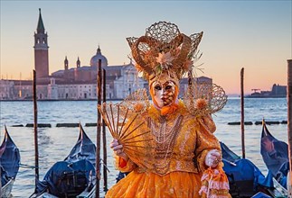 Carnival mask on the waterfront at sunrise, Venice