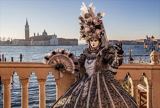 Carnival mask on the waterfront in front of San Giorgio Island, Venice