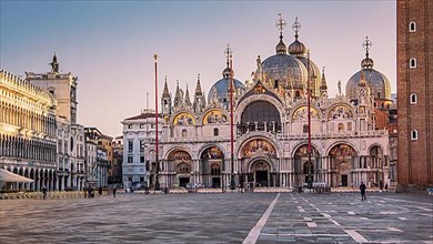 St. Mark's Square with clock tower and St. Mark's Basilica at sunrise, Venice