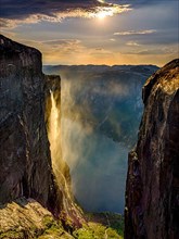 Waterfall cascades over the rocks of Kjerag into the Lysefjord and is blown away by the wind, Lyseboten