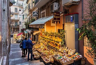 Old town alley with fruit and souvenir stand, Taormina