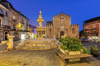 Cathedral square with fountain and cathedral at dusk, Taormina