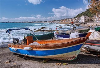 Sea surf in front of the promenade with fishing boats, Giardini-Naxos