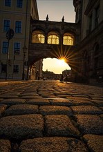 Evening light with sun star in the cobbled streets of Dresden, Germany