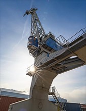 Loading crane with sun star in the port of Karlsruhe, Germany