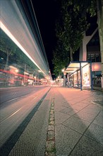 Long exposure of a passing tram at night in the city centre of Jena, Jena Thuringia