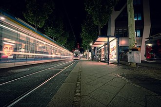 Long exposure of a passing tram at night in the city centre of Jena, Jena Thuringia