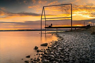 Sunset jetty on the stone beach in Unteruhldingen on Lake Constance, Germany