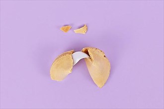 Cracked fortune cookie with note without text,