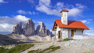 Chapel in front of rock massif Drei Zinnen mountains, Dolomites