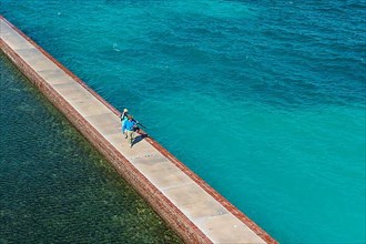 Tourists walking on a Pier surrounding Fort Jefferson, Dry Tortugas National Park