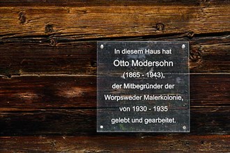 Info sign on wooden wall, Otto Modersohn the co-founder of the Worpswede painters' colony lived and worked in this house from 1930-1935