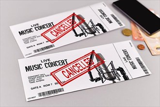 Concept for cancelled entertainment events with concert tickets and red cancelled stamp on them,