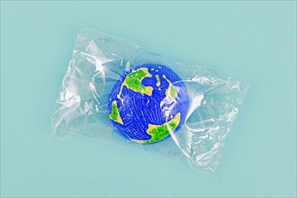 Small planet earth model wrapped in plastic,
