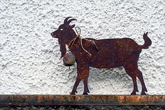 Iron rusty goat in front of house wall, Hindelang