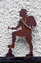 Iron rusty climber in front of house wall, Hindelang