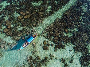 Aerial from a fishing boat gliding through the pristine waters of Koh Lipe, Tarutao National Park