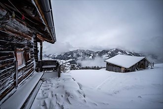 Snowfall, mountain hut in the snow