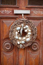 Wreath with Easter eggs on an old house door, Old Town