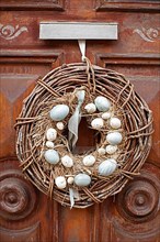 Wreath with Easter eggs on an old house door, Old Town