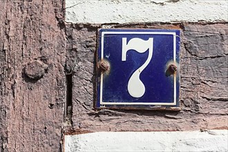 House number sign, number seven on an old half-timbered house
