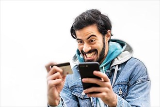 Latin man using credit card to make online payment on smartphone. mixed-race man using cellphone for shopping online. Guy using smart phone to check credit card transactions from app. White background...