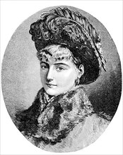 Portrait of a young woman with short blond hair, fur collar and a cap