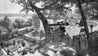 Holiday, young man enjoying the summer at a laid table in the garden