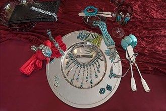 Rhinestone jewellery and accessories decorated on a silver plate and red cloth, Bavaria