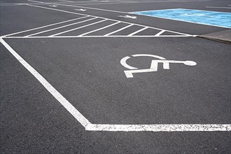 Markings for disabled vehicles and pedestrians in the car park at Olafsvik Church, Isl