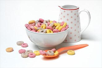 Fruit-flavoured cereal rings in bowl and spoon, children's breakfast