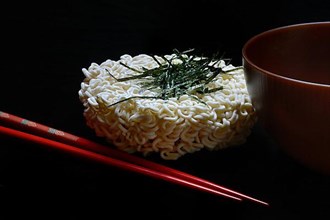 Nori, cut paper-like sheet of seaweed and Asian noodles with chopsticks