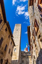 Family tower and medieval buildings against a blue sky, San Gimignano