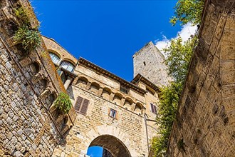 Family tower and medieval buildings against a blue sky, San Gimignano