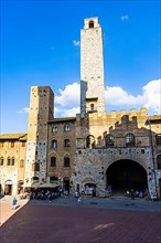 Gender towers and medieval buildings against a blue sky, San Gimignano