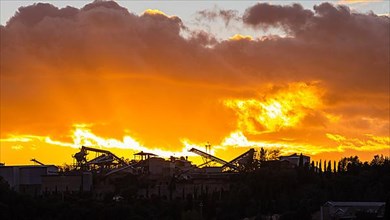 Sunset over a cement plant, near Petroio
