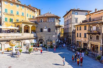 Tourists strolling through the Piazza della Republica, Cortona