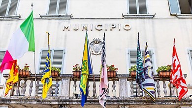 Coloured flags at the town hall of Asciano, Asciano