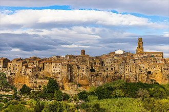 Panoramic view of the medieval town of Pitigliano, dark clouds above