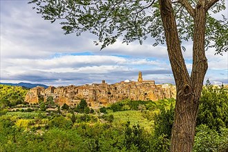 Panoramic view of the medieval town of Pitigliano, dark clouds above